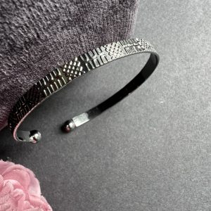 Black metal bracelet with design