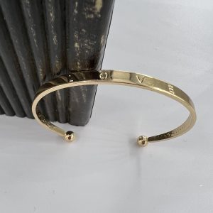 Gold plated bangle with love engraved on it