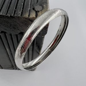 Silver plated bangle with decorative design