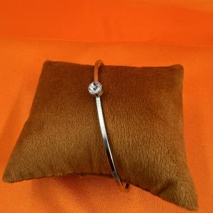 Bangle with gemstone set in centre